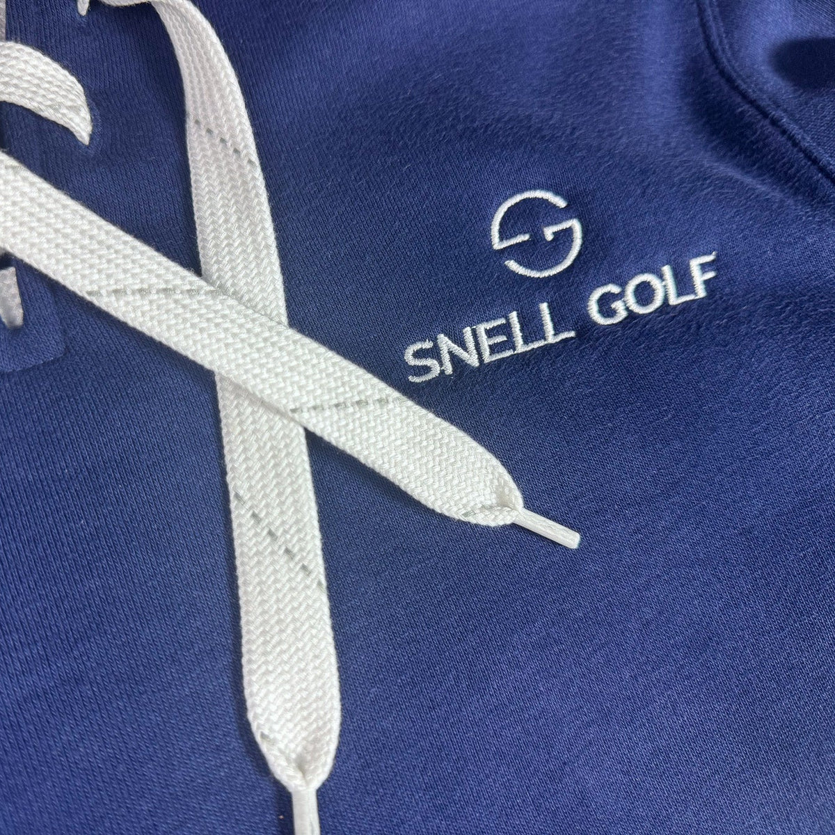 Blue sweatshirt with white hockey laces and Snell Golf logo
